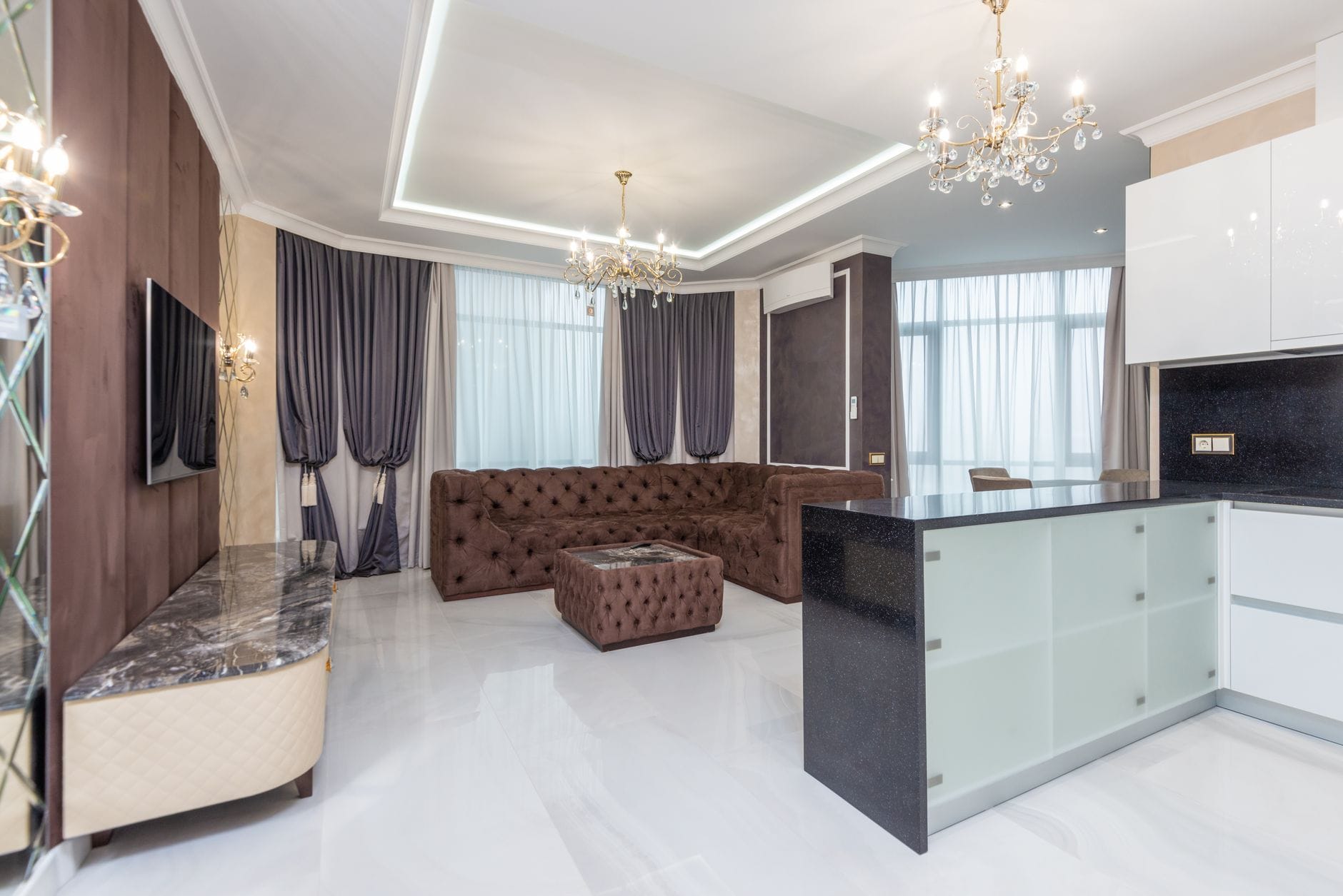 Jak wybrać idealne mieszkanie inwestycyjne pod wynajem premium Luksusowy, przestronny salon z żyrandolem i elegancką, jasną sofą